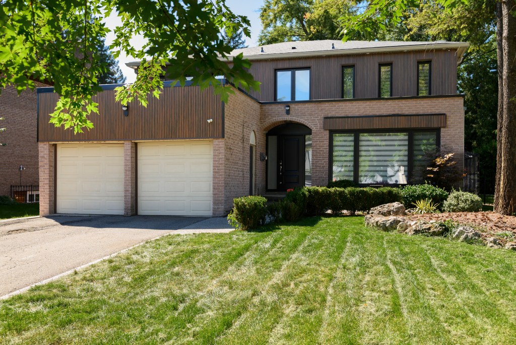 House with wood-grain siding and a double garage