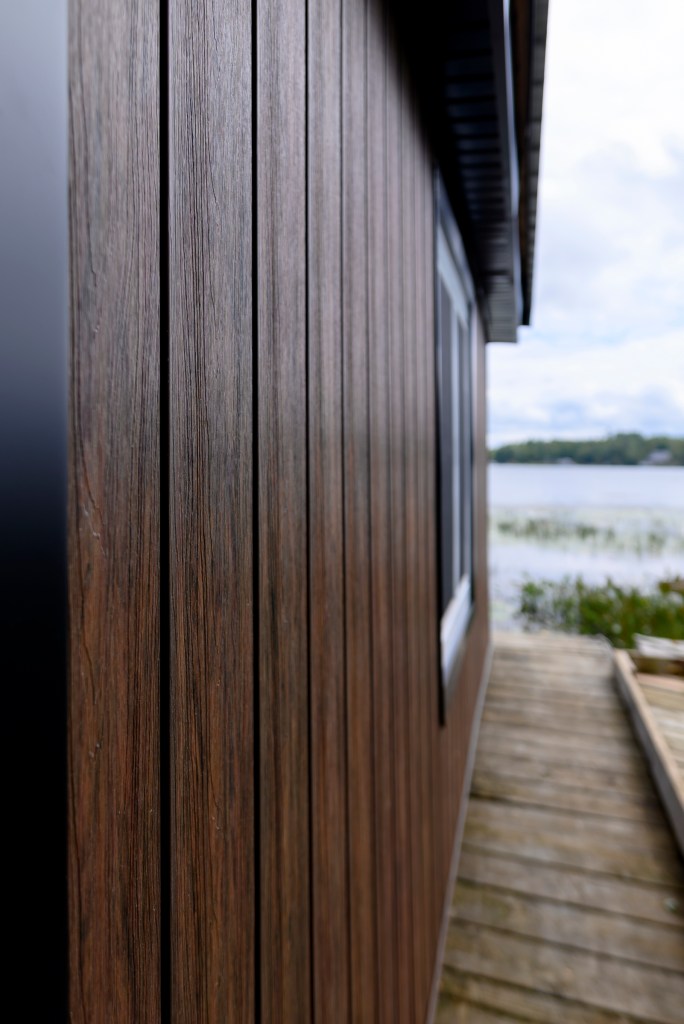 Vertical wood-grain siding on a lakefront building