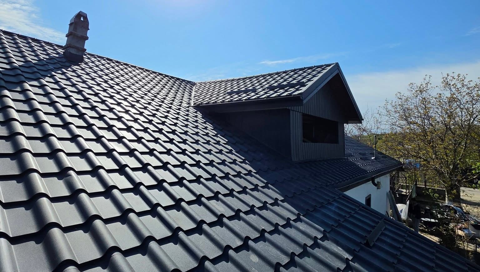Metal roof under clear blue sky on residential home